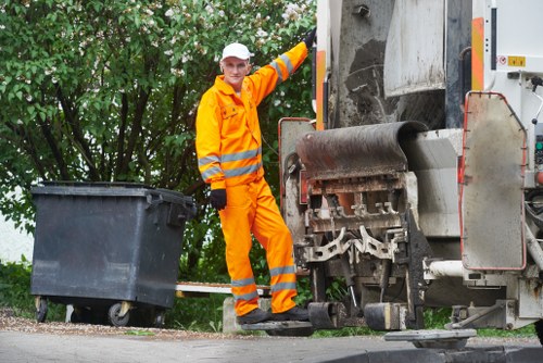 Professional team handling large garden waste materials